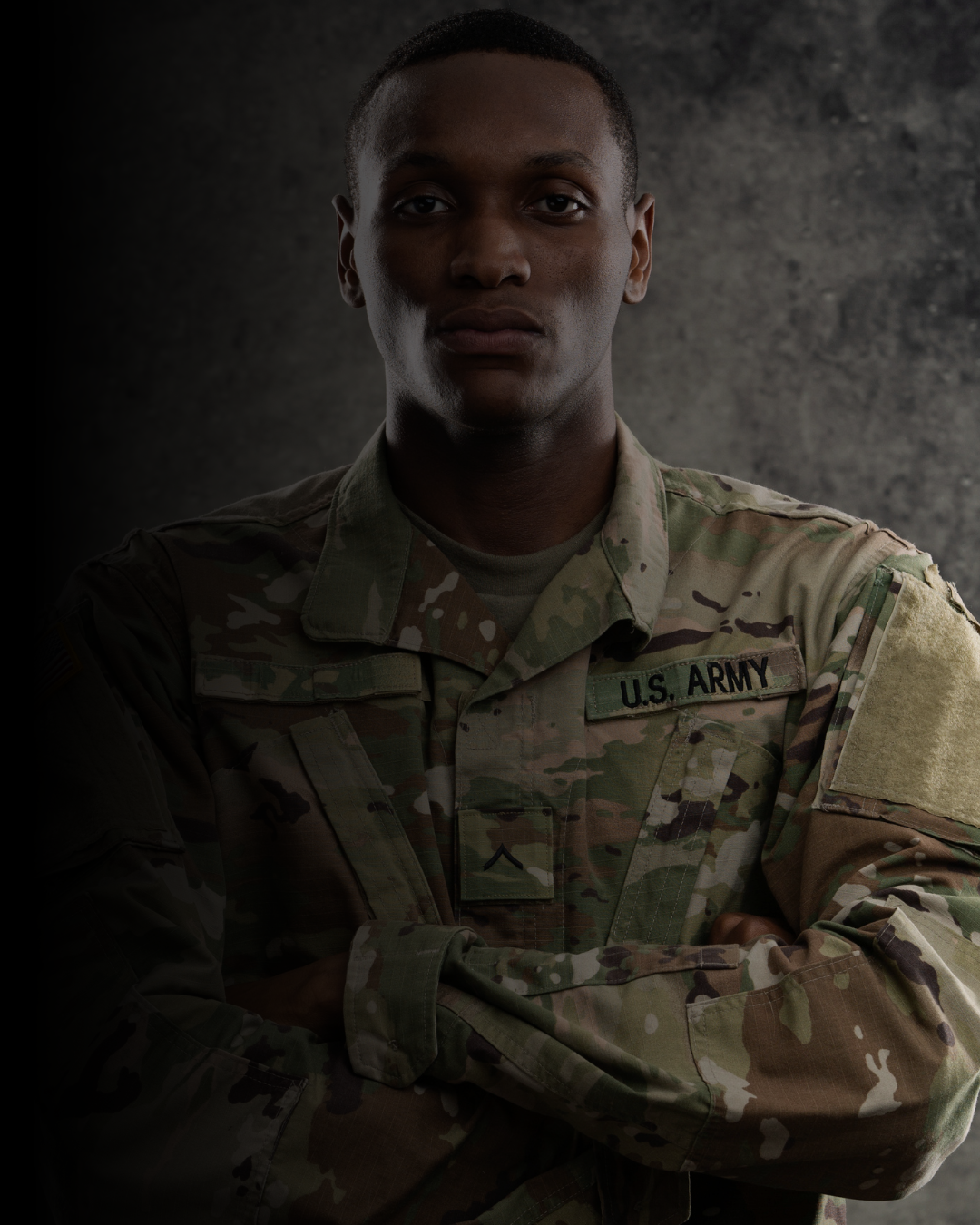 Person wearing a U.S. Army uniform with a dark background